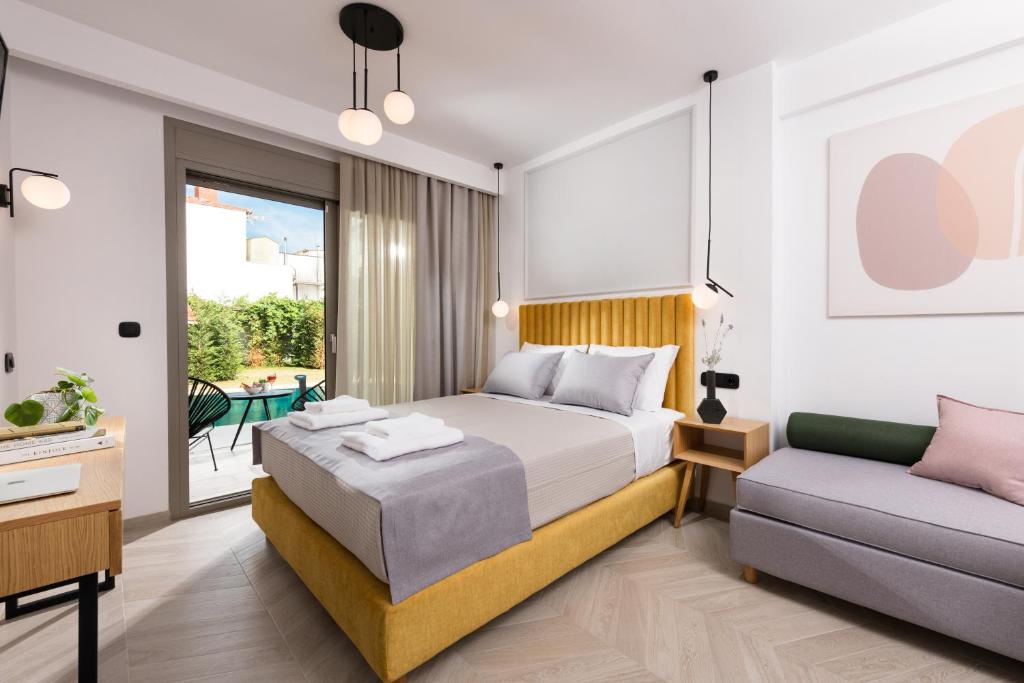 a bedroom with a bed and a couch at Alkyon Hotel in Limenas