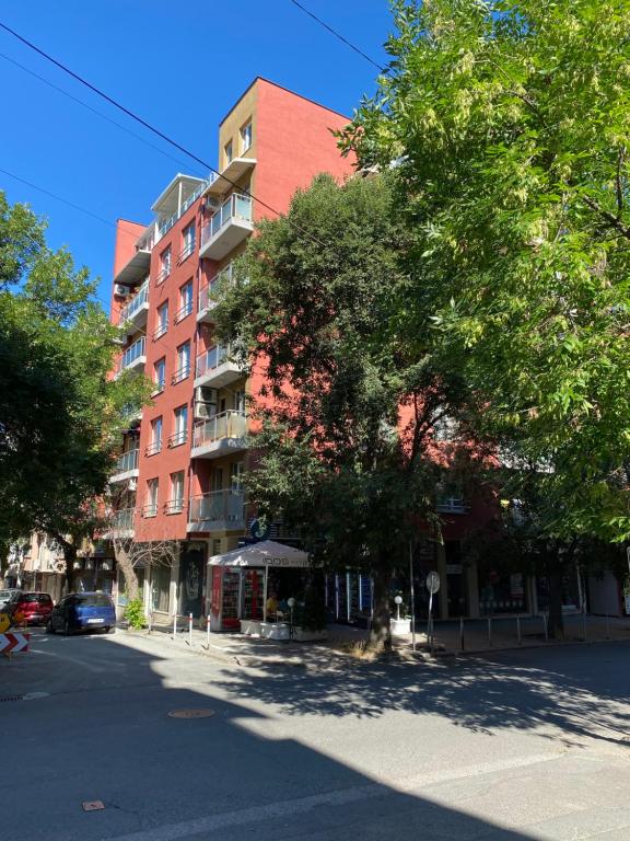 een lege straat met een hoog rood gebouw bij Markoni 3 in Boergas