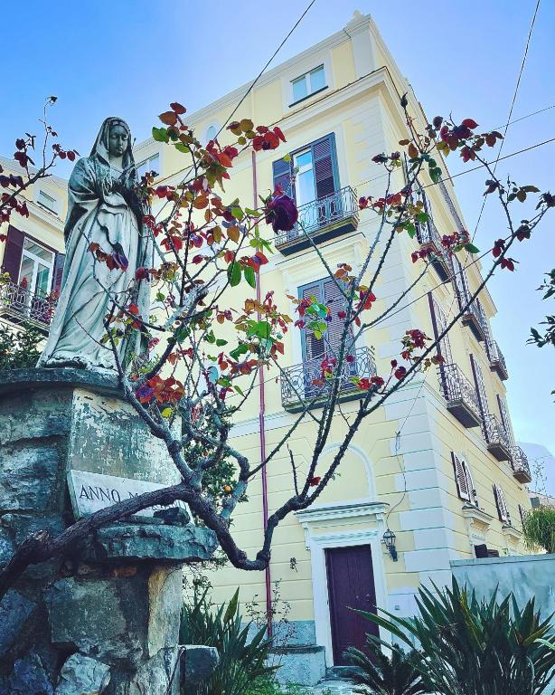 a statue of a woman in front of a building at Coco's Apartment in Meta