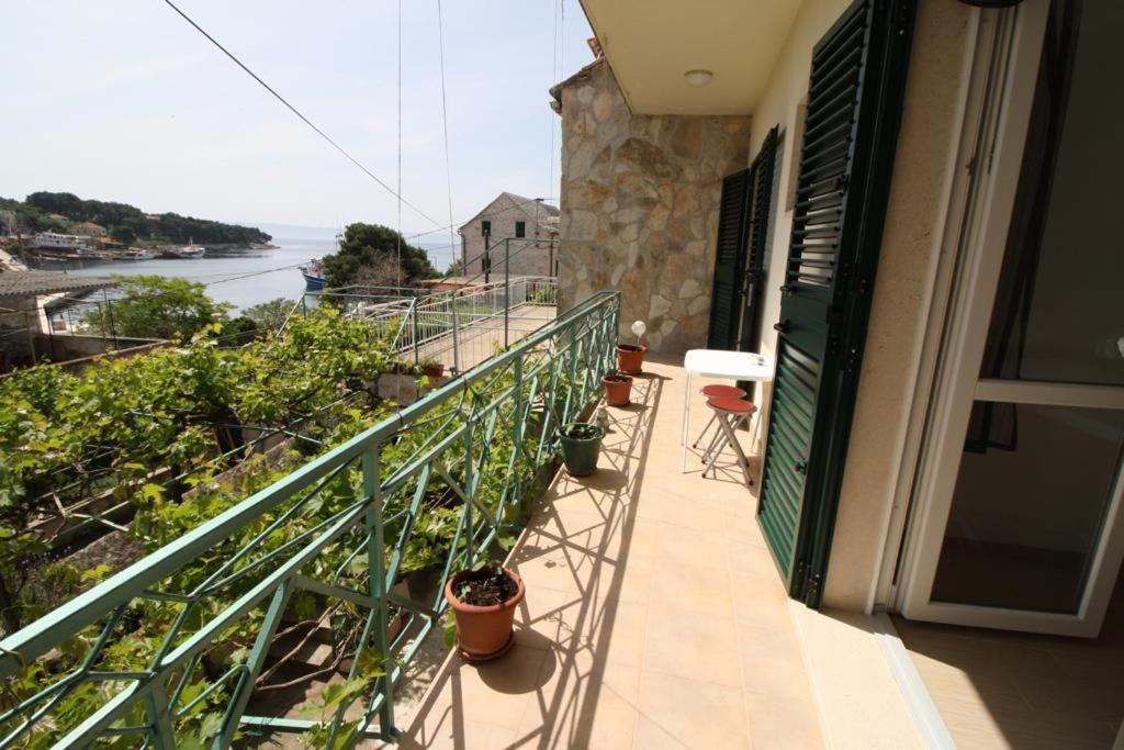 a balcony of a house with a view of the ocean at Apartment Gita in Sumartin