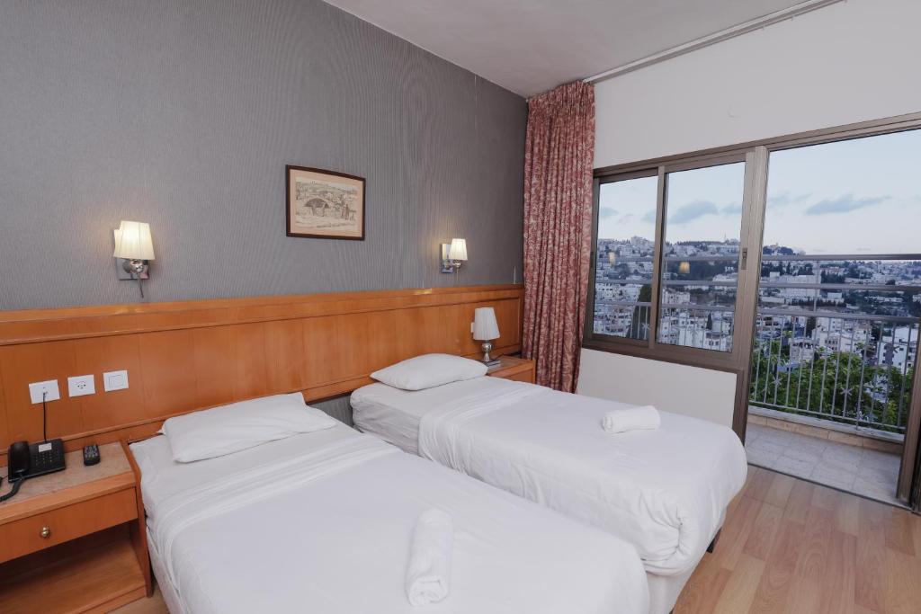 Postel nebo postele na pokoji v ubytování Tabar Hotel