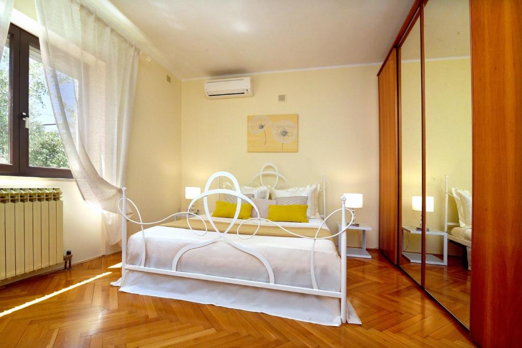 sypialnia z białym łóżkiem i oknem w obiekcie Holiday Home Villa Margherita w Puli