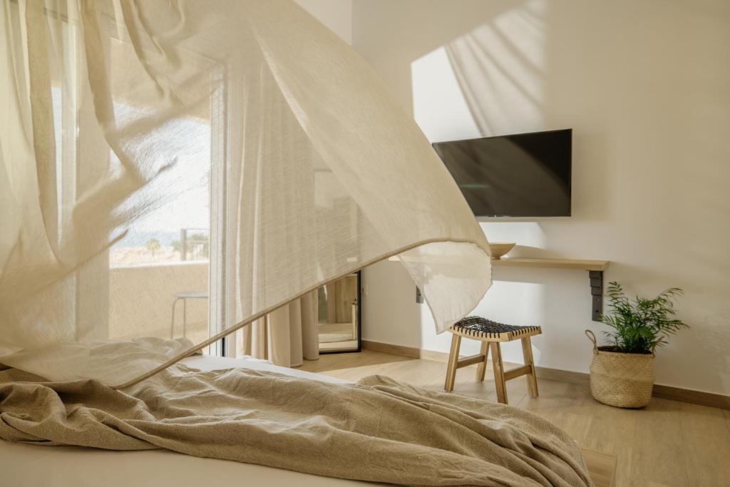 a bedroom with a bed and a window at Casa Costa Suites in Kanali