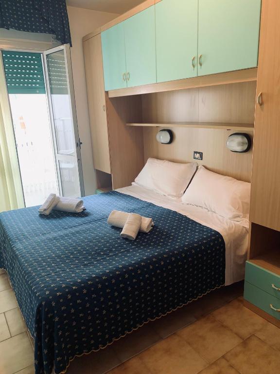 Postel nebo postele na pokoji v ubytování Hotel Al Capitano