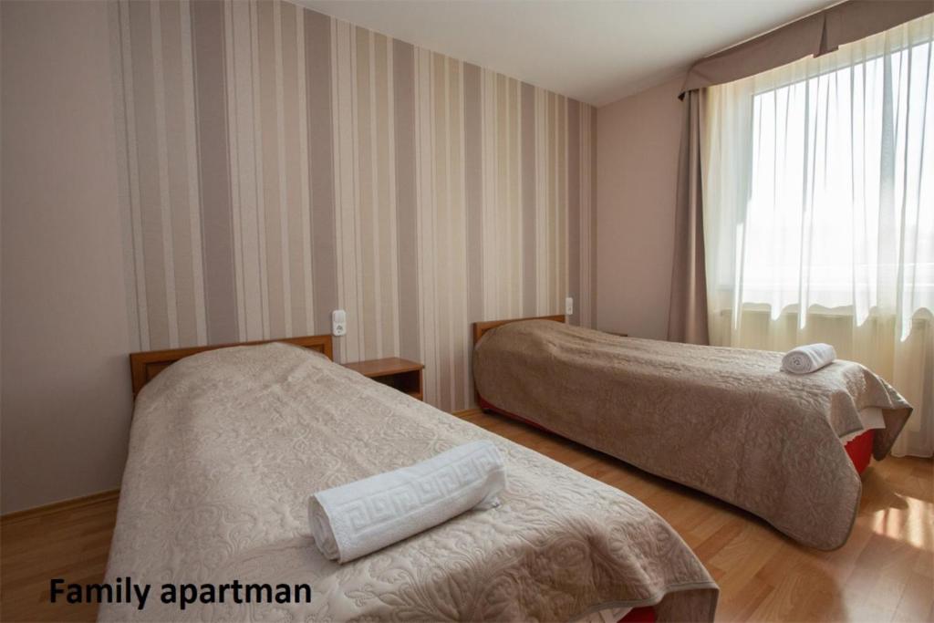 Postel nebo postele na pokoji v ubytování Liza Apartmanok