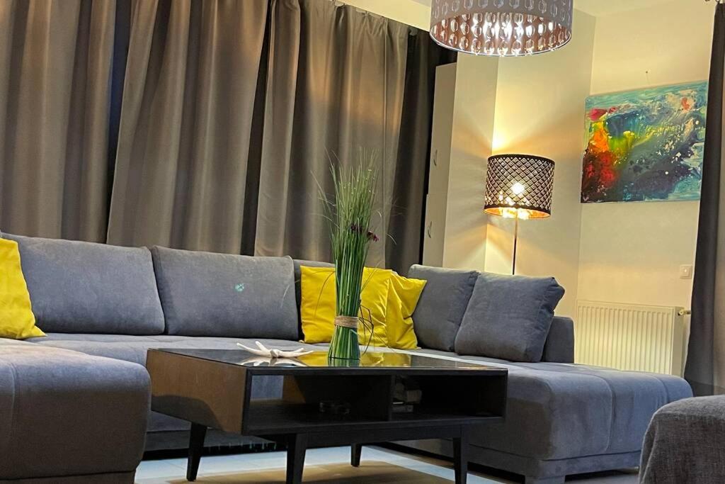 a living room with a couch and a table at Apartment Happiness by Nicole Jutka, visual artist Olimp in Olimp