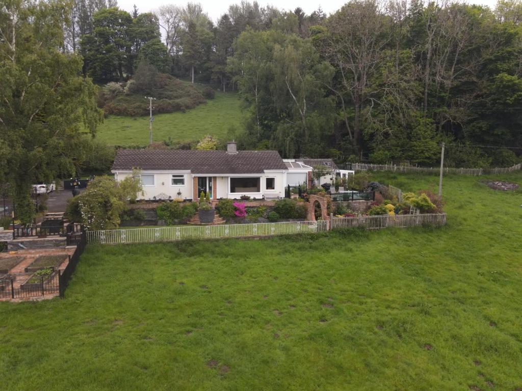 a house in the middle of a yard at Padog B&B in Llanrwst