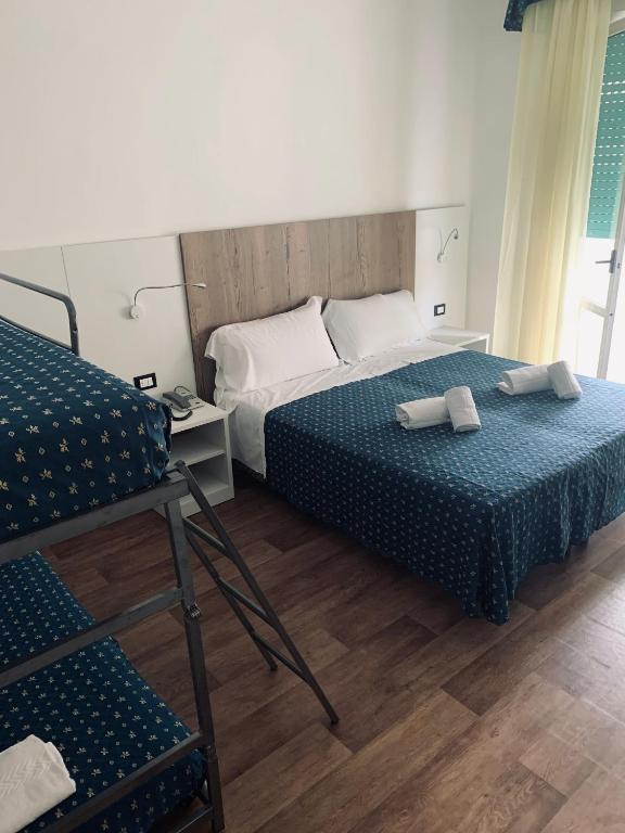 Postel nebo postele na pokoji v ubytování Hotel Al Capitano