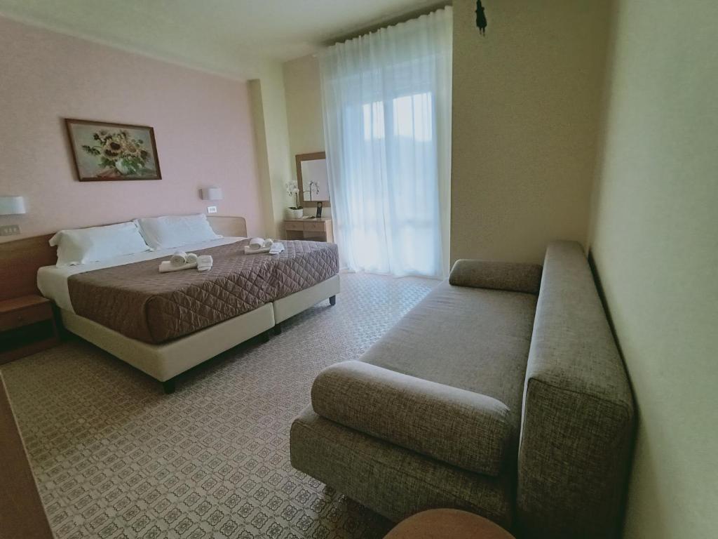 Postel nebo postele na pokoji v ubytování Hotel Rossella