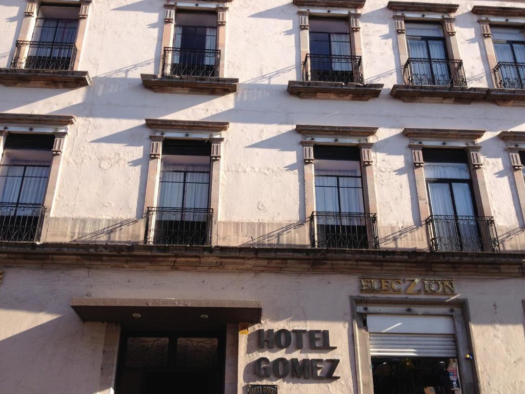 a facade of a building with windows and balconies at Hotel Gomez de Celaya in Celaya