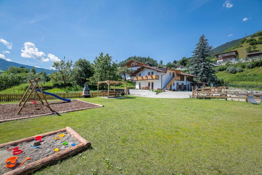 a yard with a playground with a play equipment at Der Söllhof in Bressanone