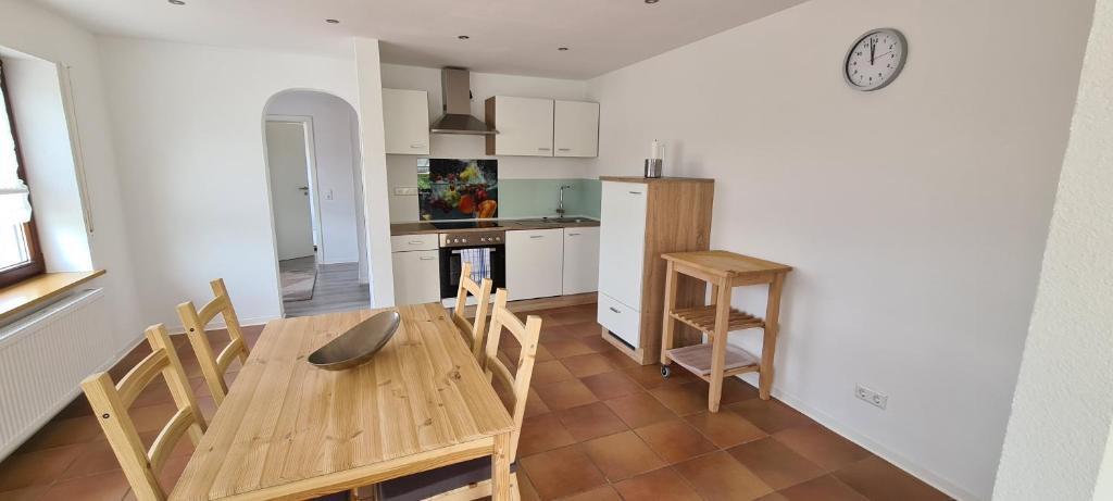 a kitchen and dining room with a wooden table and chairs at Ferienwohnung An der Kapelle in Rickenbach