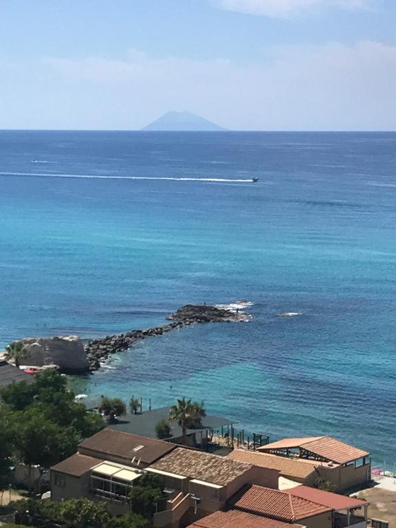 a view of the ocean with a boat in the water at Nereide in Tropea