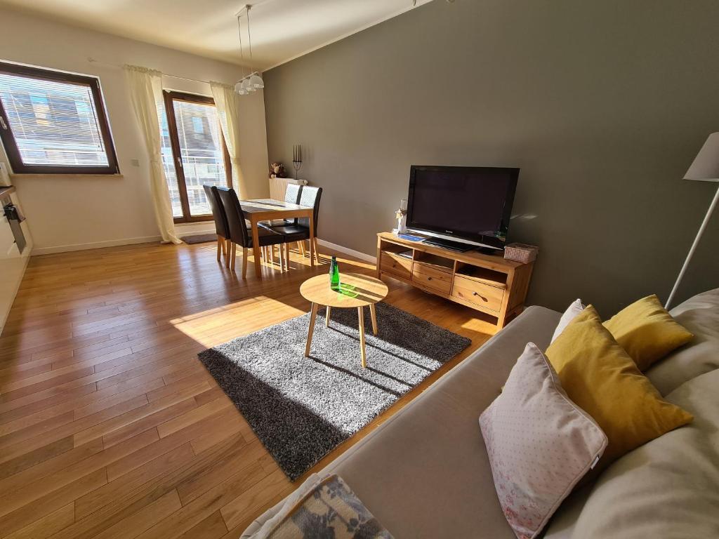 a living room with a couch and a table at Warsaw Apartment Sarmacka in Warsaw