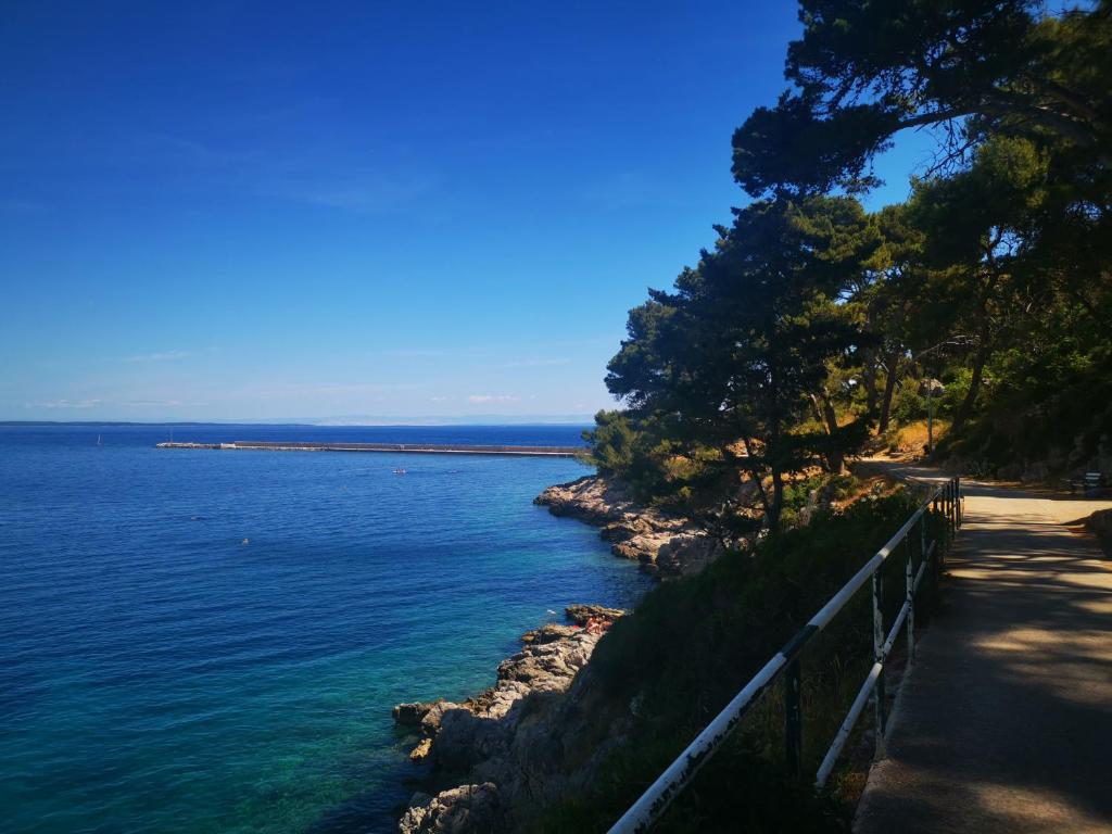a view of a body of water with a fence at VELI LOŠINJ Rovenska 52 in Veli Lošinj