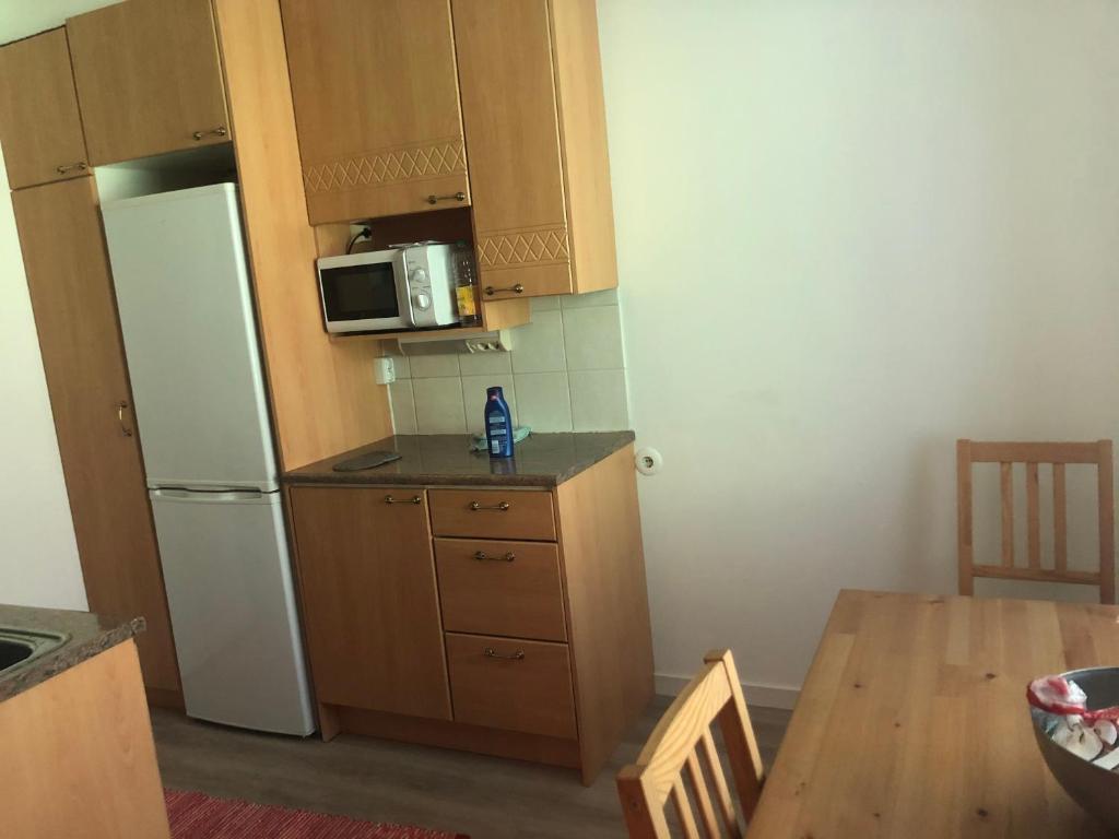 una piccola cucina con un frigorifero bianco e un tavolo di Mimmo 1 a Vantaa