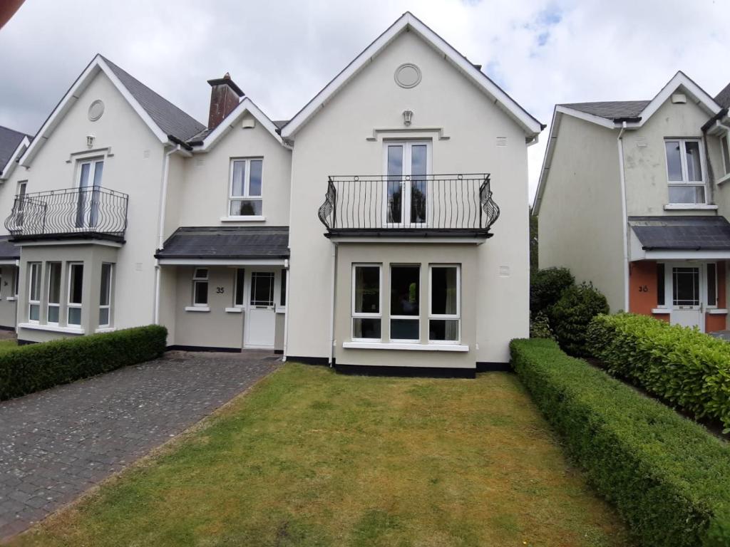 a large white house with a yard at Mount Wolseley Holiday Home - Privately Owned in Tullow