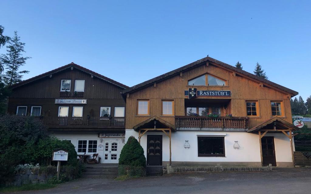 a large wooden building with a balcony at Pension Raststüb'l in Sorge