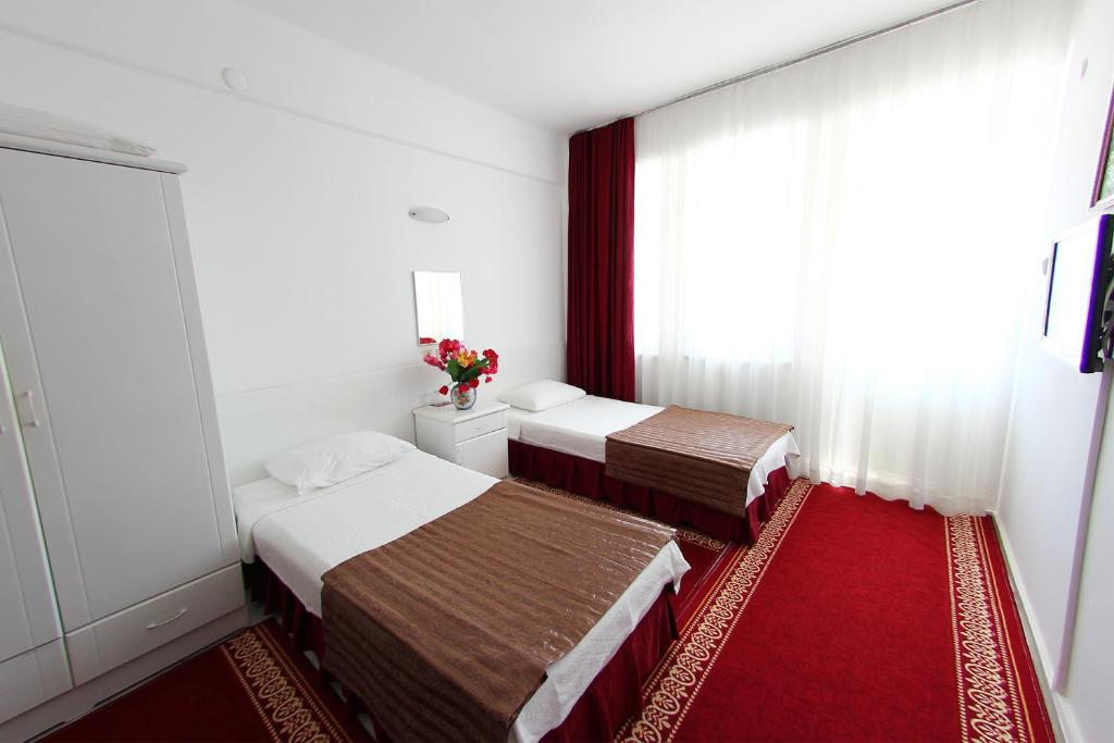 A bed or beds in a room at Soykan Hotel