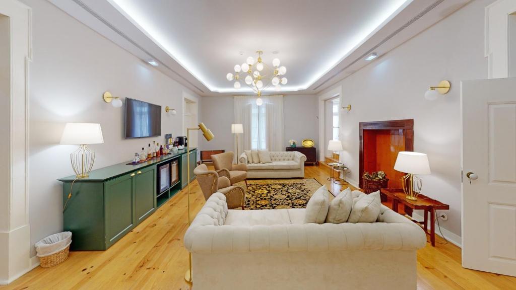 a living room with two couches and a tv at Casa dos Ofícios Hotel in Tomar