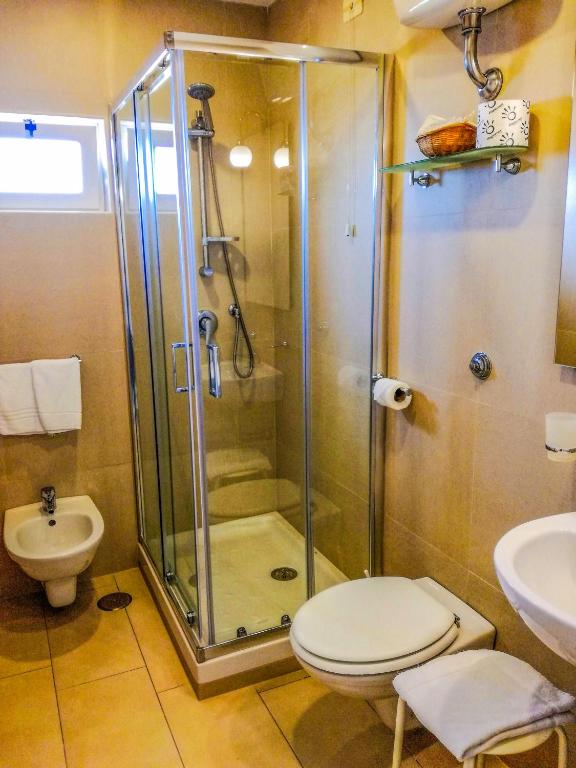 a bathroom with a shower and a toilet and a sink at Hotel Villa Fiorita in Sorrento