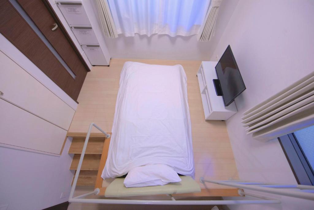Postel nebo postele na pokoji v ubytování Laffitte Tokyo