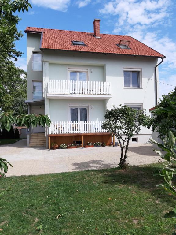 a large white house with a red roof at Eisenstadt Apartments in Eisenstadt