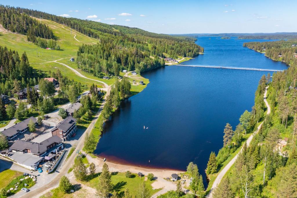 an aerial view of a lake with a house at Rinnetupa Apartment in Tahkovuori