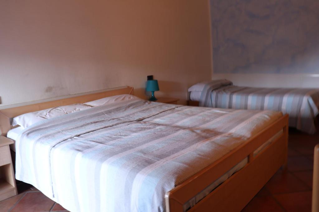 Posteľ alebo postele v izbe v ubytovaní Le Camere Dell'Ancora