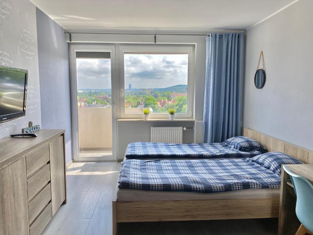 a bedroom with two beds and a window at Apartament Sopot No. 1 in Sopot