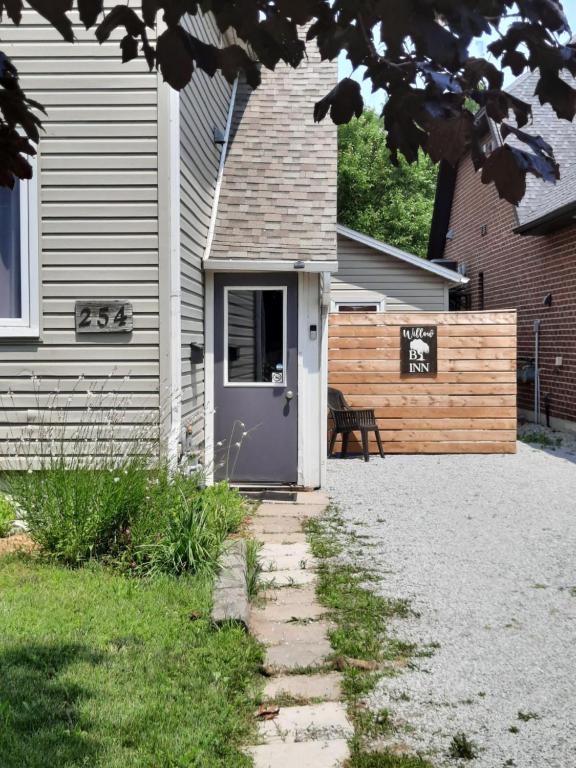 a house with a door and a bench next to it at Willow B Inn in Kingsville