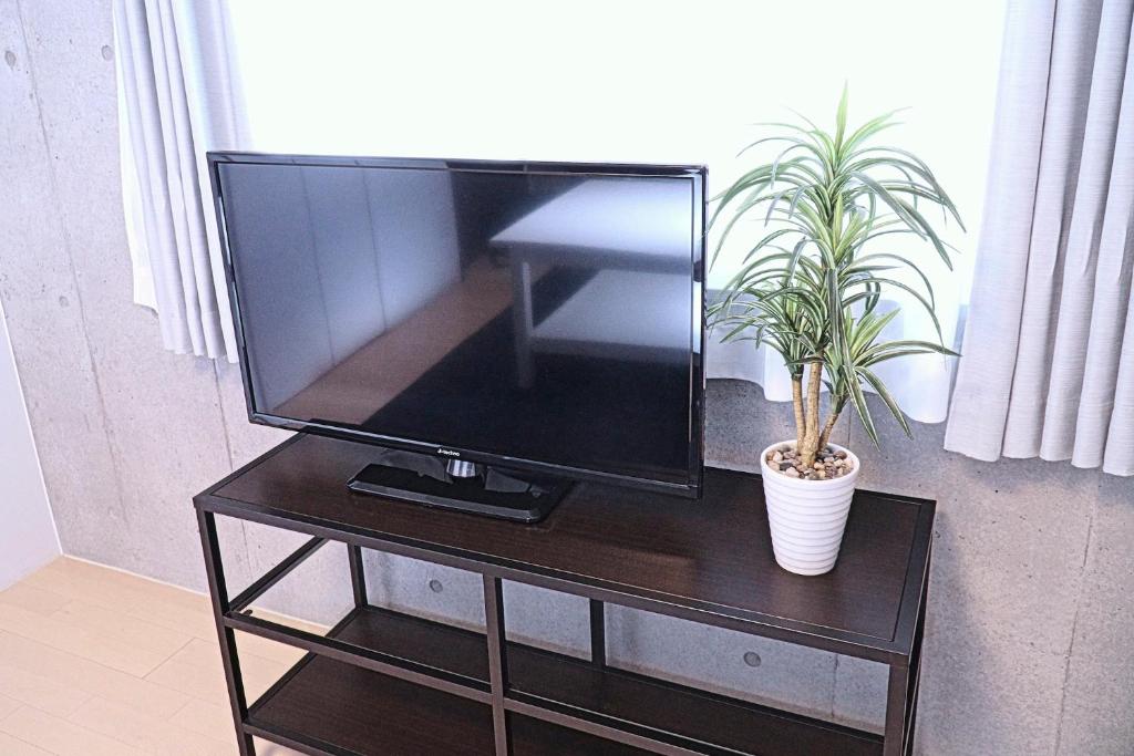 TV a/nebo společenská místnost v ubytování Laffitte Tokyo