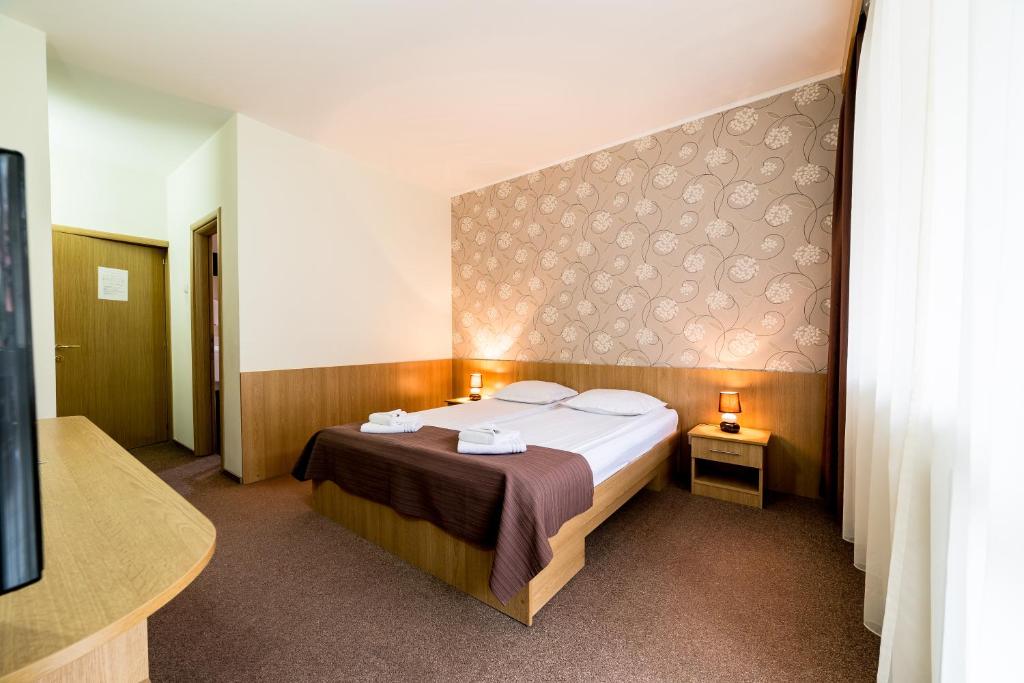 Postel nebo postele na pokoji v ubytování Hotel Muresul Health Spa