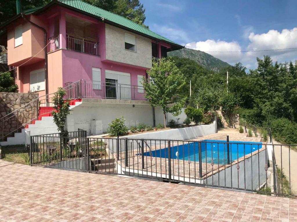 a house with a fence and a swimming pool at Neretva River Guesthouse in Konjic