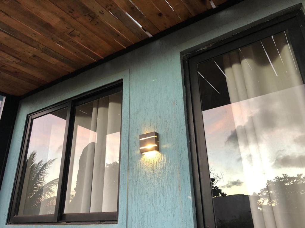 une lumière sur le côté d'une maison avec une fenêtre dans l'établissement Oby Noronha, à Fernando de Noronha