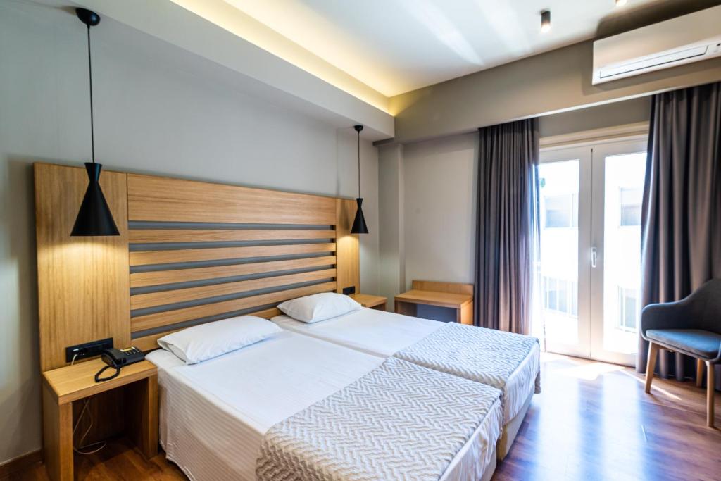 a hotel room with a bed and a window at Agamemnon Hotel in Nafplio