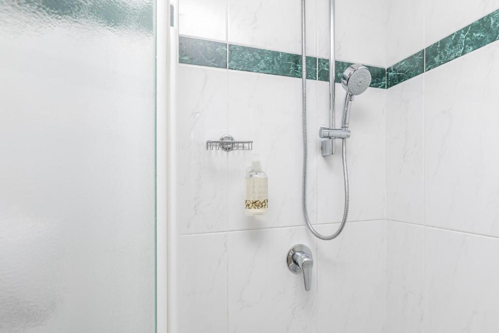 a shower with a glass door in a bathroom at Hotel Impero in Cremona