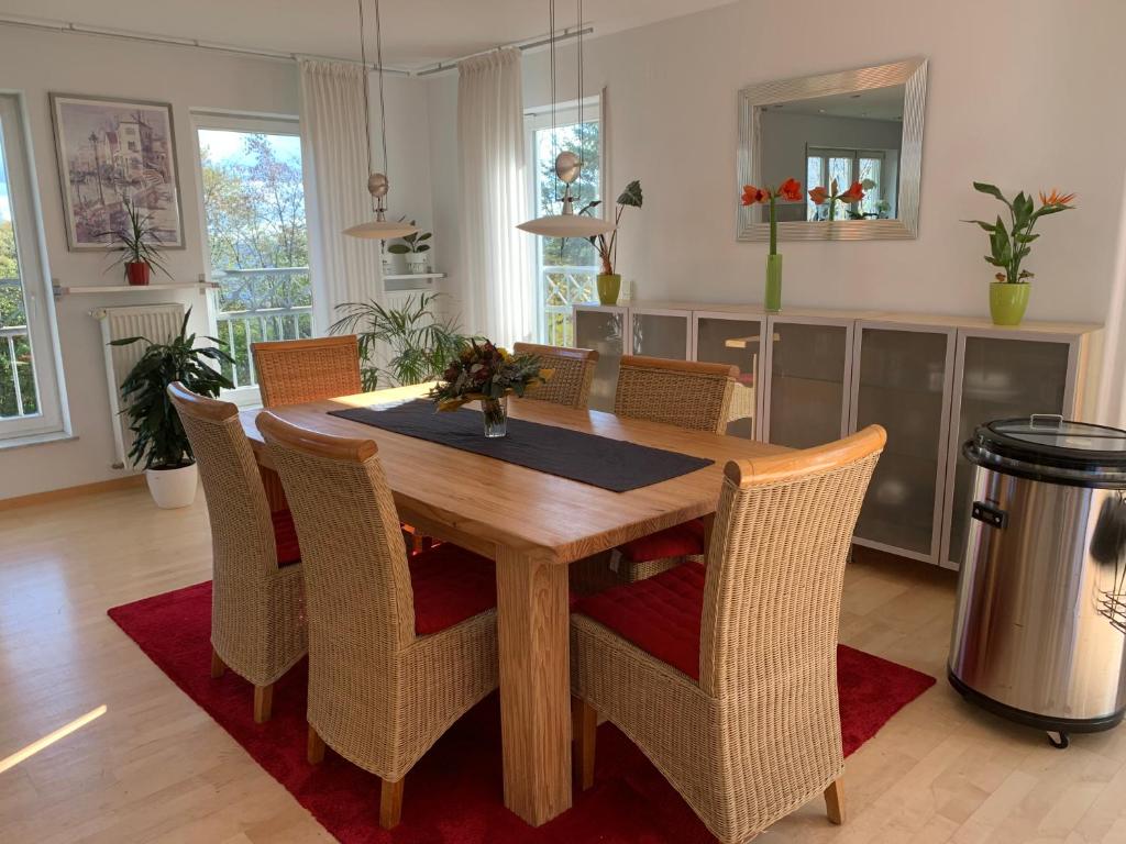 a dining room with a wooden table and chairs at Boardinghouse Saargau in Überherrn