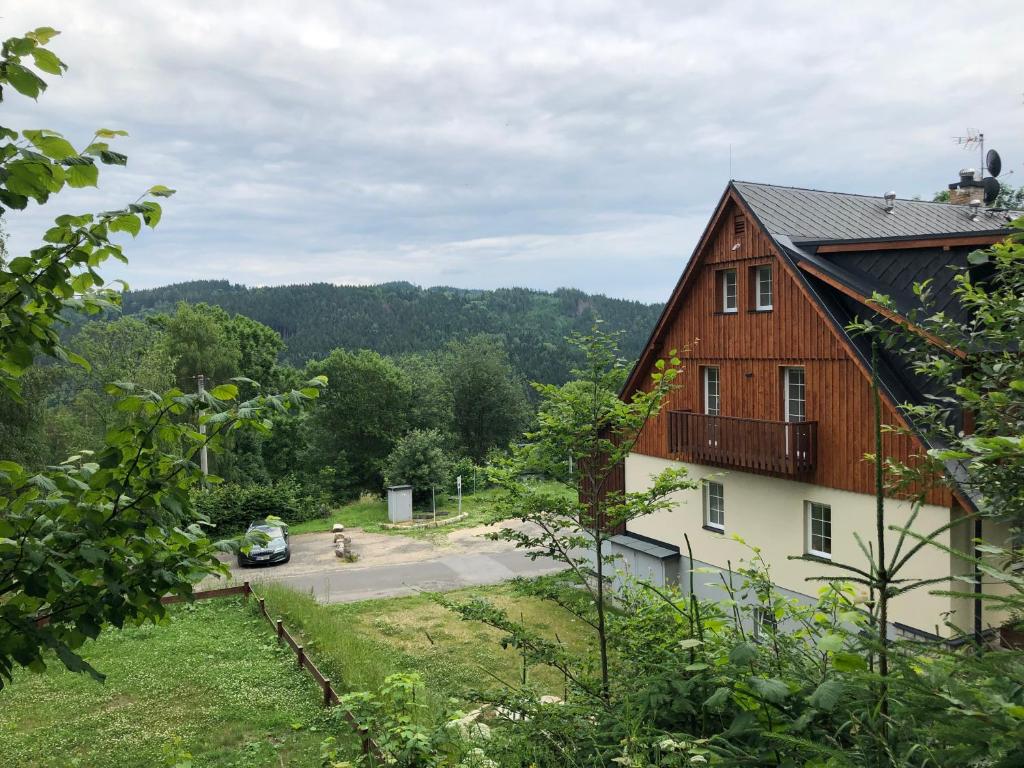 a barn with a car parked in front of it at Apartmán Janina in Janov nad Nisou