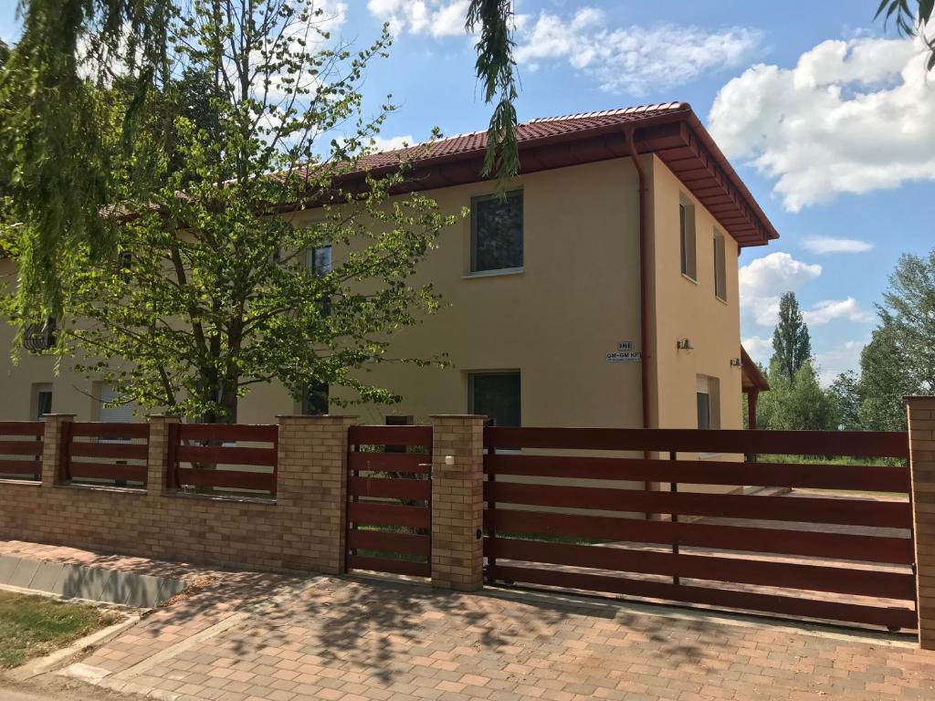 dom z płotem przed nim w obiekcie Szárszószép Villa w mieście Balatonszárszó