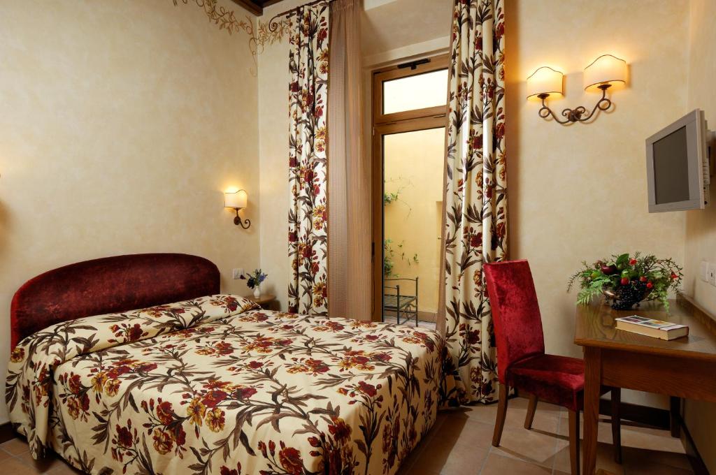 Łóżko lub łóżka w pokoju w obiekcie Residenza San Calisto