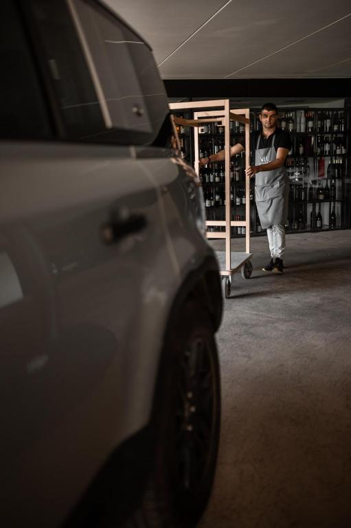 a young boy is standing in a wine store at Miramonti Boutique Hotel in Avelengo