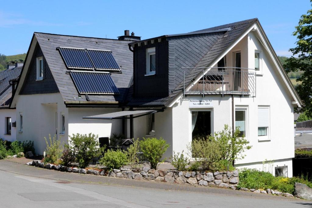 a house with solar panels on the roof at Ferienwohnung Im Tal Olsberg in Olsberg