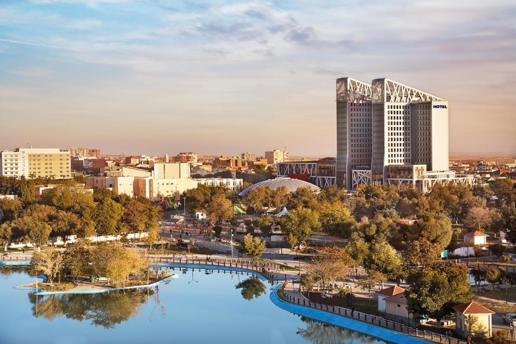 a view of a city with a river and a building at Park Mall Hotel & Conference Center in Sétif