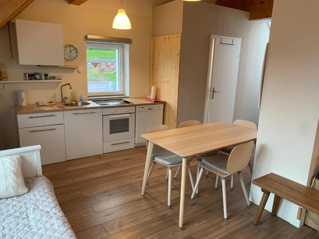 a kitchen and dining room with a table and chairs at Book-A-Room City Apartment Salzburg in Salzburg