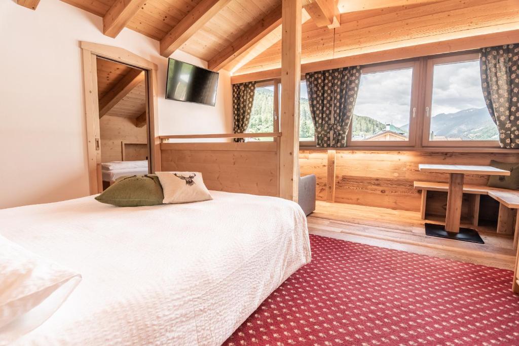 Postel nebo postele na pokoji v ubytování Hotel Genzianella