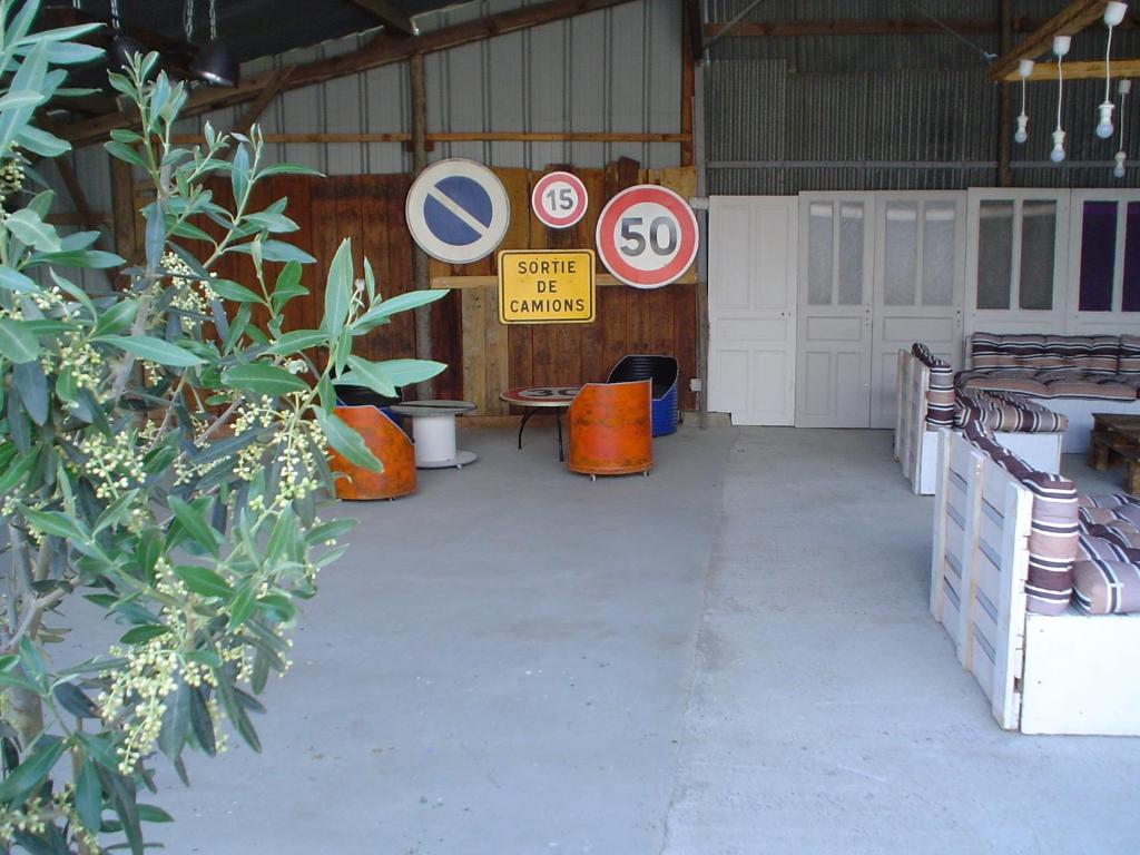 un garage avec des panneaux sur son côté dans l'établissement Les Gites de la Musardière, à Meusnes