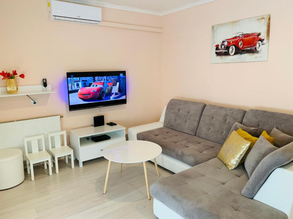 a living room with a couch and a flat screen tv at Apartament Komfort Centrum Ustroń in Ustroń