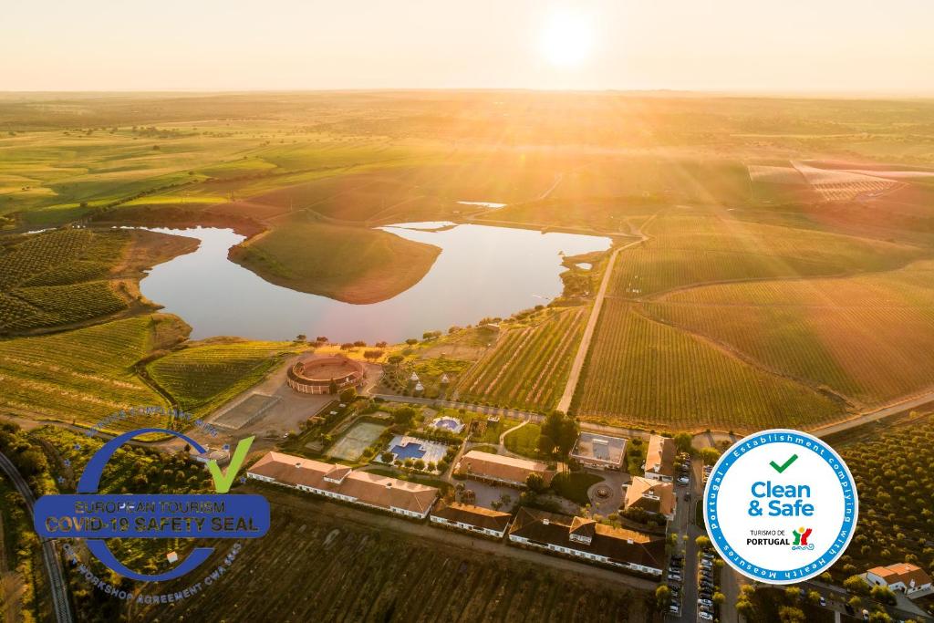 an aerial view of a field and a lake at Vila Gale Alentejo Vineyard - Clube de Campo in Albernoa