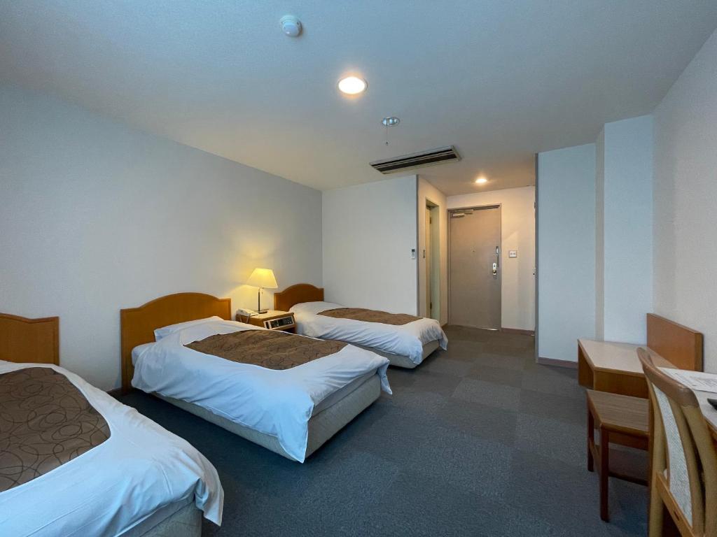 Postel nebo postele na pokoji v ubytování Hotel Ginsui
